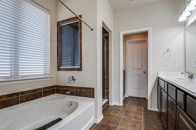 a bathroom with a bathtub and shower