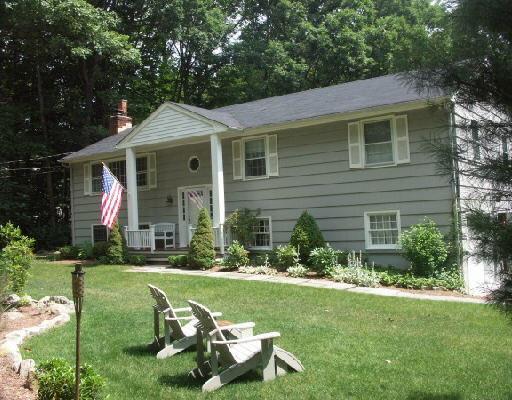 270 Linden Tree Road Wilton, CT 06897 - Photo 1 of 1 a front view of a house with a garden and plants