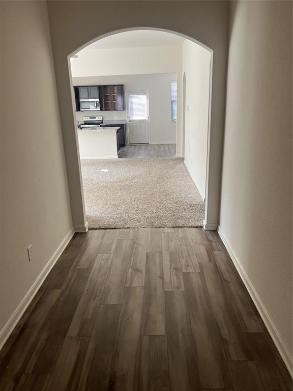 135 Morning Glory Sanger, TX 76266 - Photo 4 of 9 a view of a kitchen from a hallway