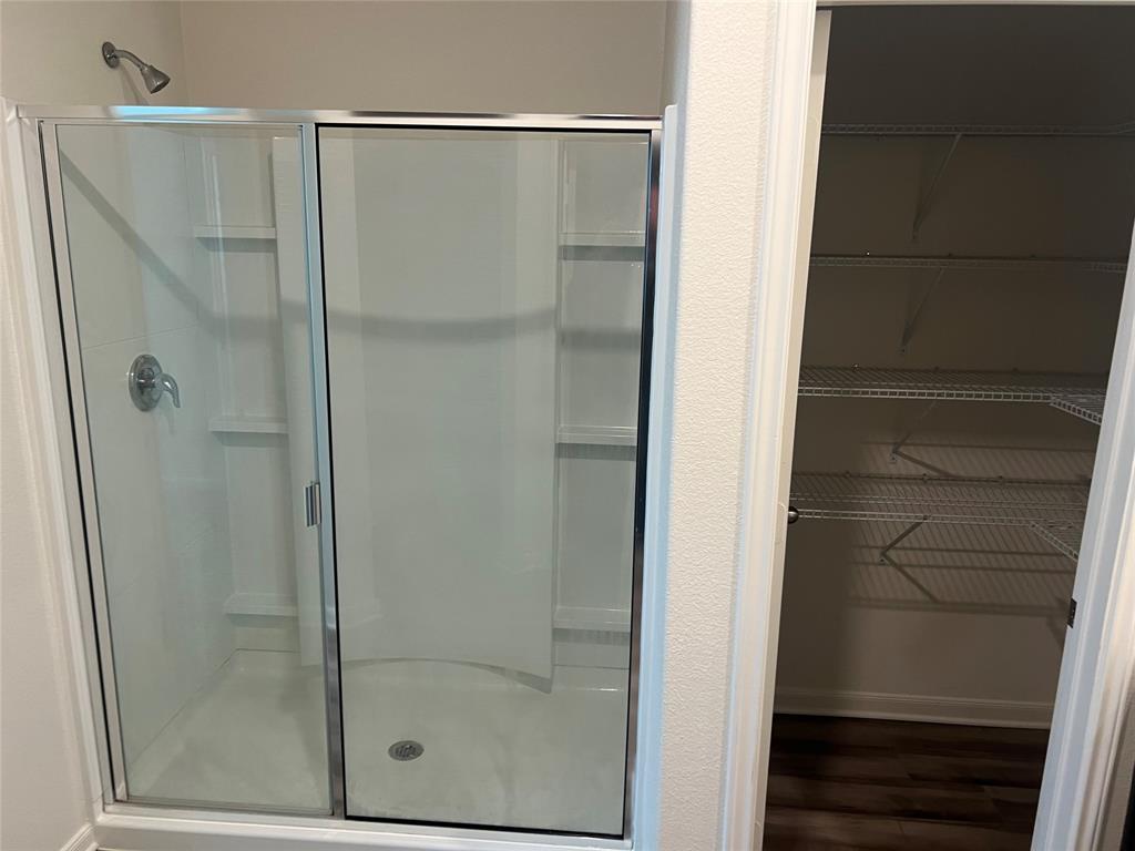 135 Morning Glory Sanger, TX 76266 - Photo 7 of 9 a bathroom with a glass shower door