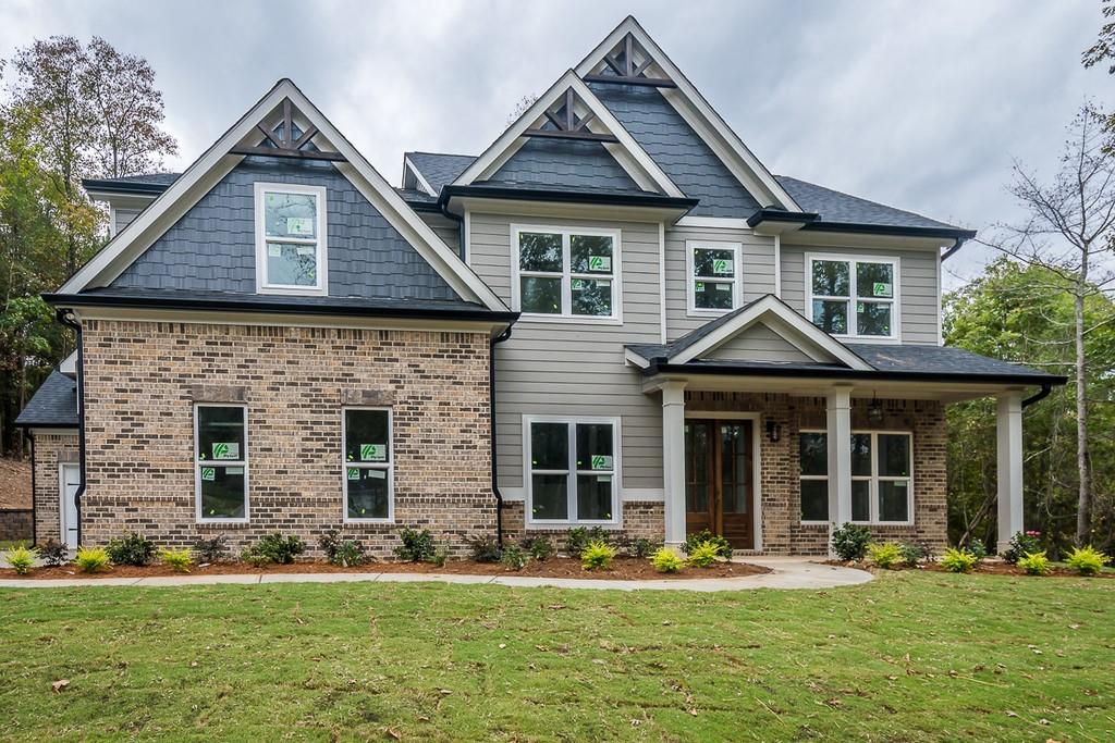 Exterior Front  features beautiful Rocking Chair Porch Double Entry Doors and custom lighting.