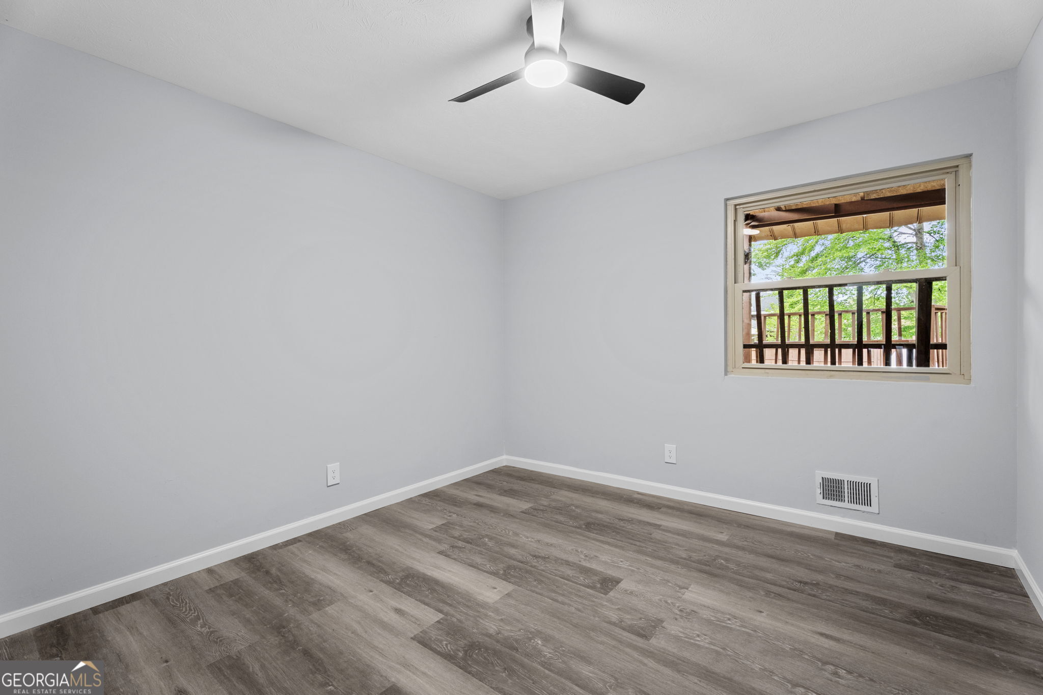 6463 Maddox Road Morrow, GA 30260 - Photo 26 of 46 a view of an empty room with wooden floor and a window