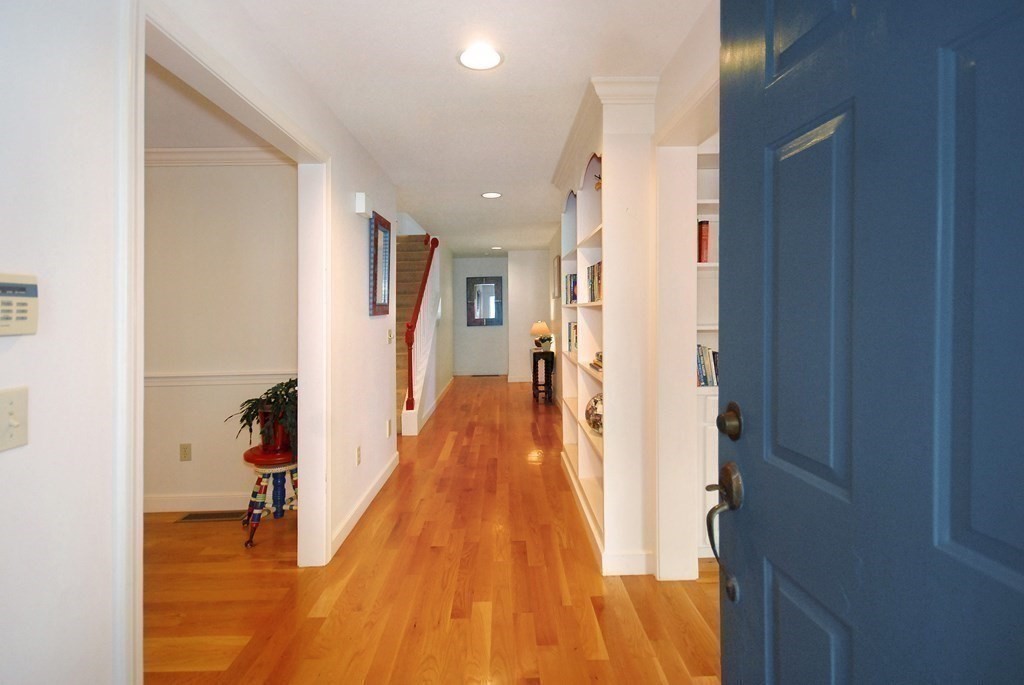 6 Winterberry Path, Unit 6 Acton, MA 01720 - Photo 12 of 24 a view of a hallway with wooden floor and a bathroom