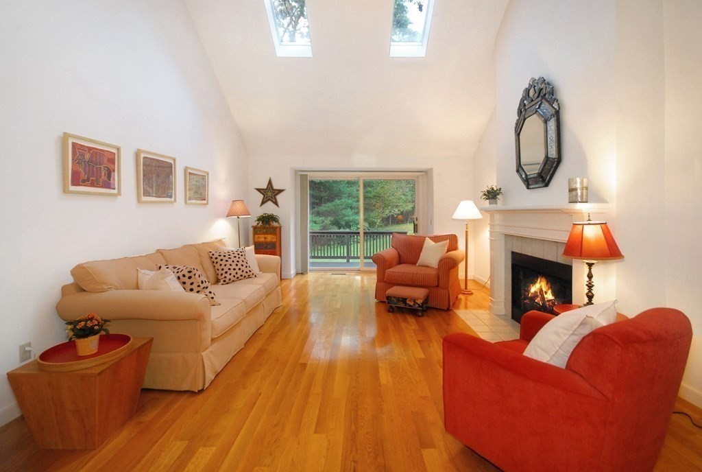 6 Winterberry Path, Unit 6 Acton, MA 01720 - Photo 15 of 24 a living room with furniture a fireplace and a flat screen tv