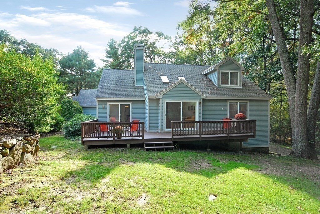 6 Winterberry Path, Unit 6 Acton, MA 01720 - Photo 18 of 24 a front view of a house with a yard table and chairs