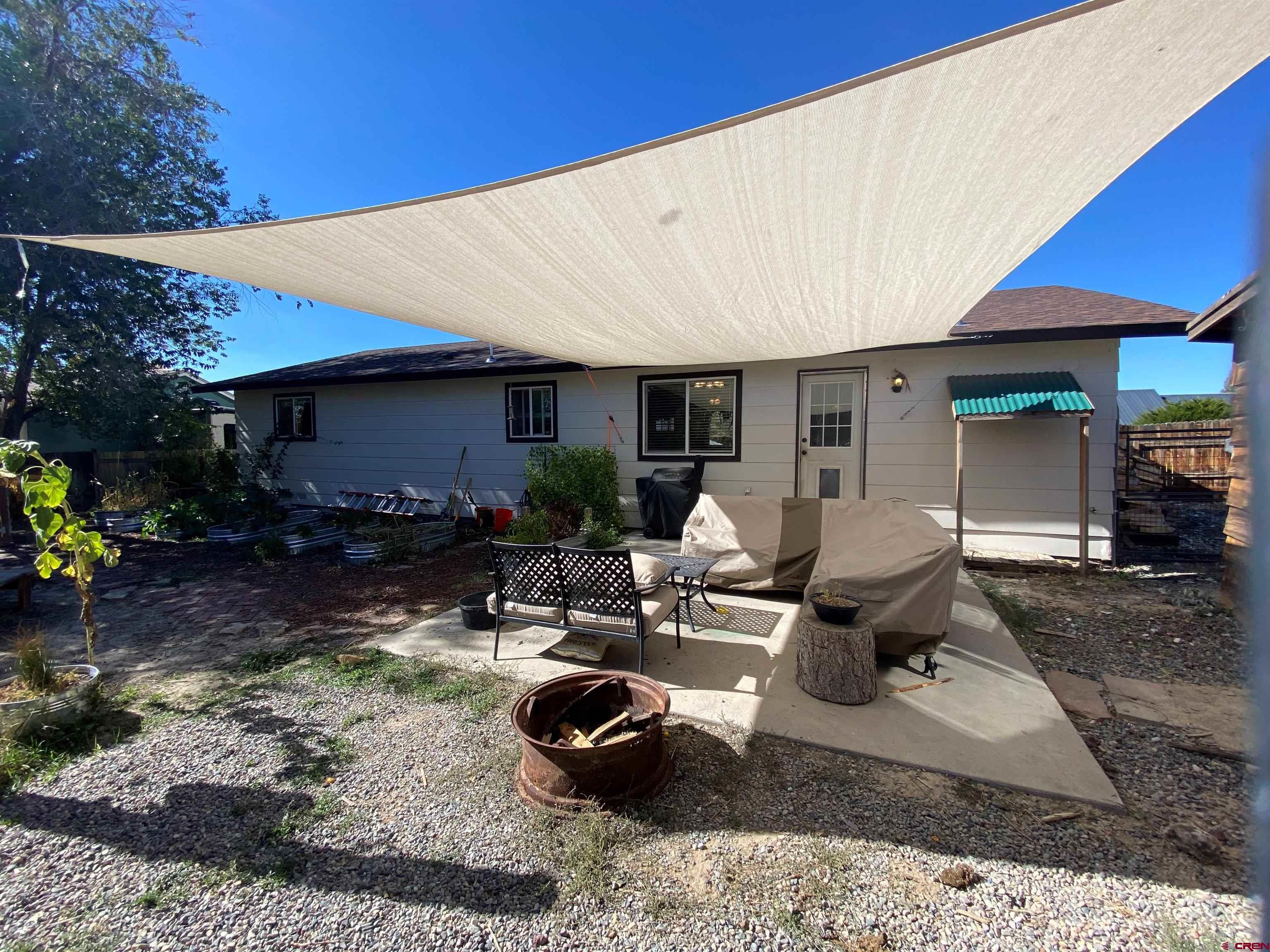 1861 Ouray Drive Montrose, CO 81401 - Photo 10 of 13 a living room with furniture a lamp and a table
