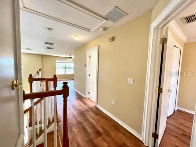 a view of a big room with wooden floor and windows in a room