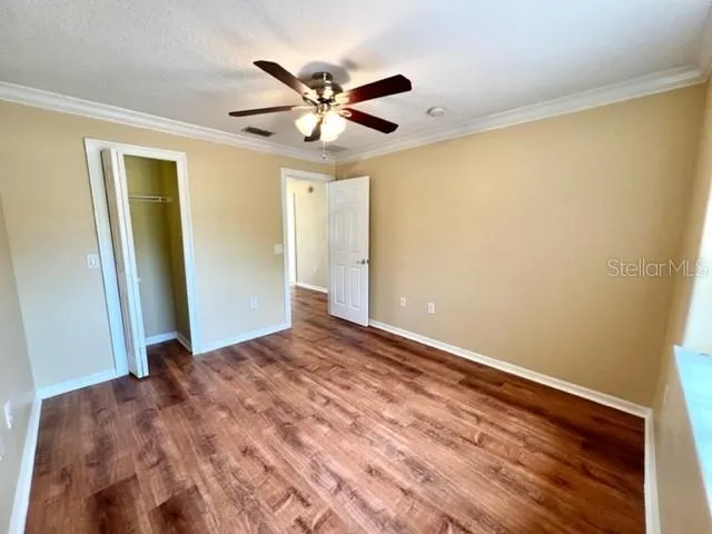 a view of a room with wooden floor and closet
