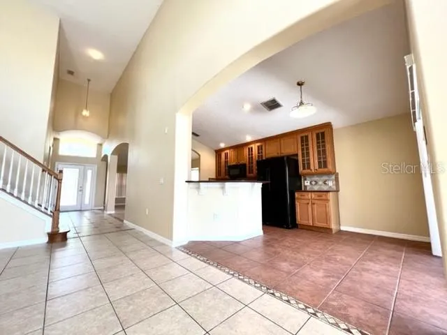 a view of a hallway with wooden floor and a living room