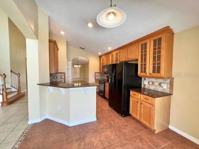 a view of a hallway with wooden floor and a living room