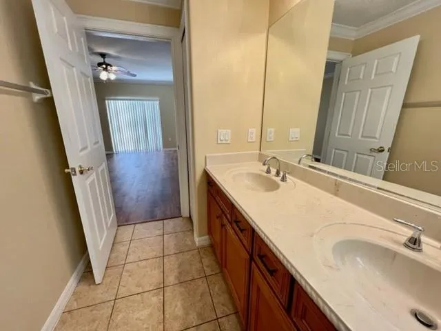 a view of a hallway with furniture and a window