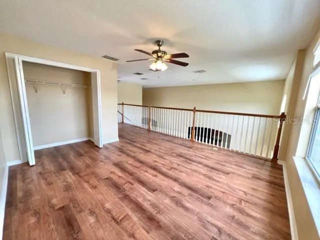 a view of a hallway view with wooden floor and furniture