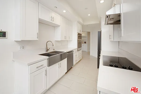 a kitchen with stainless steel appliances granite countertop a sink and a stove