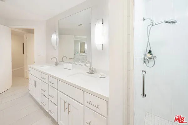 a bathroom with a double vanity sink and mirror