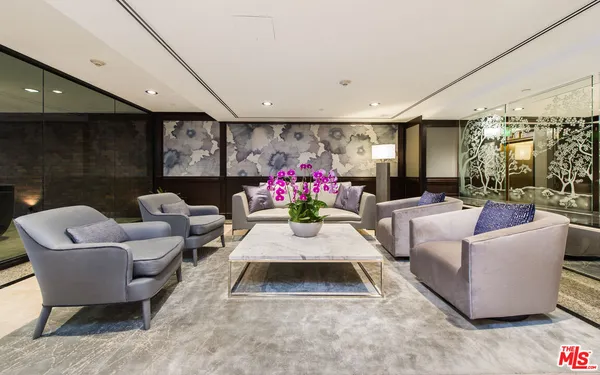 a living room with furniture flowerpot and a chandelier