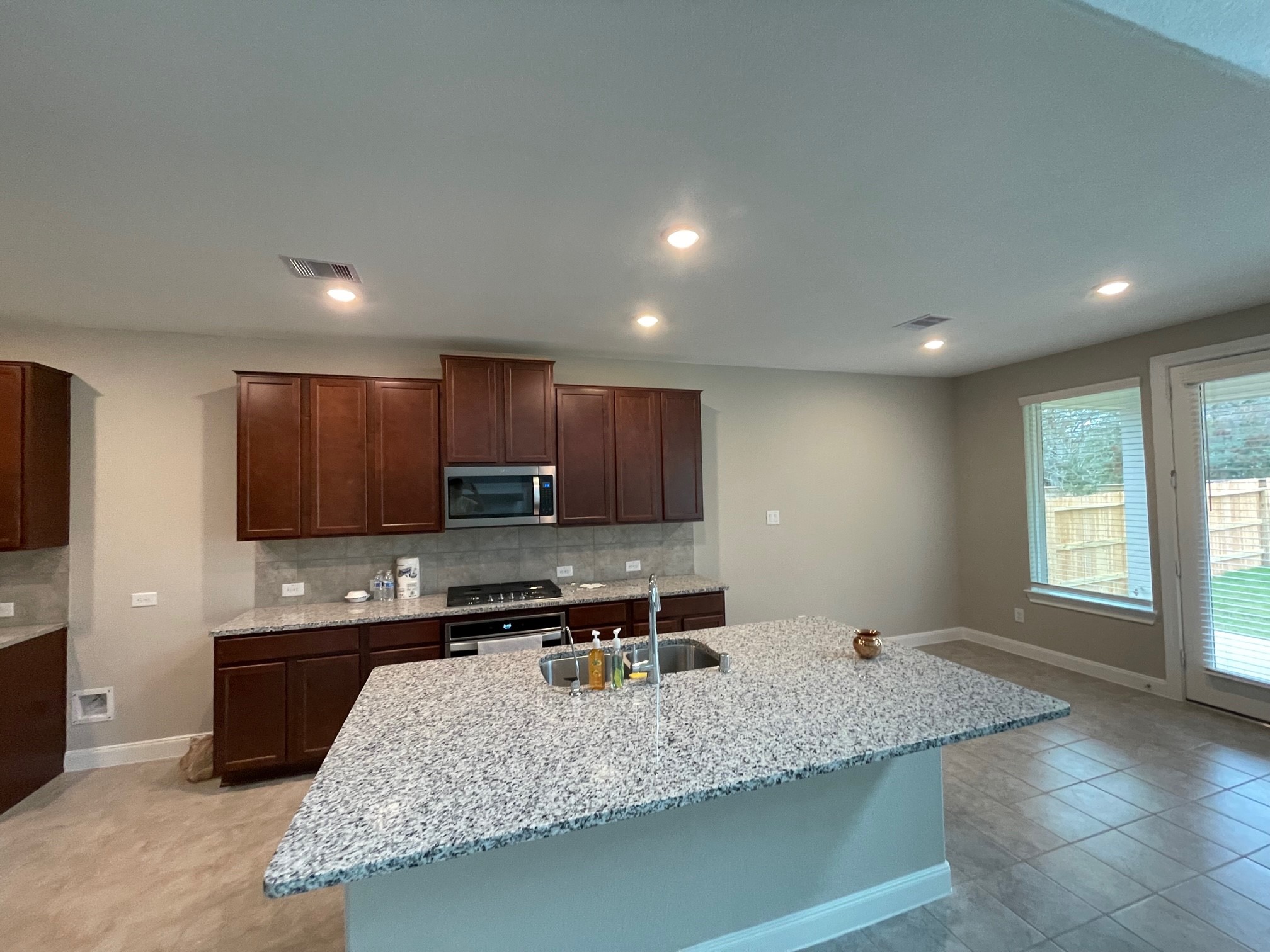 2216 Gadwall Court Conroe, TX 77384 - Photo 6 of 23 a kitchen with stainless steel appliances granite countertop a sink stove and a granite counter tops