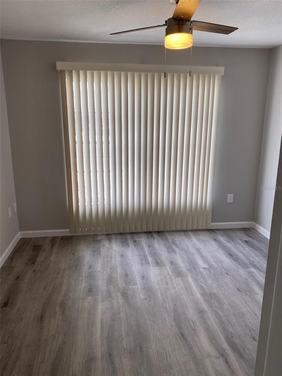 2853 Stillwell Court New Port Richey, FL 34655 - Photo 11 of 15 a view of an empty room with wooden floor and a window
