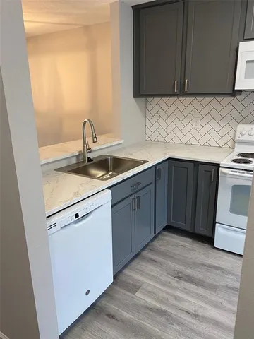 a kitchen with a sink and cabinets