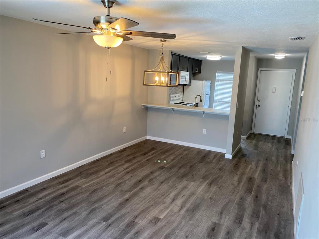 2853 Stillwell Court New Port Richey, FL 34655 - Photo 5 of 15 a view of kitchen and empty room with wooden floor