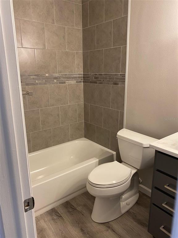 2853 Stillwell Court New Port Richey, FL 34655 - Photo 9 of 15 a white toilet and tub next to a shower