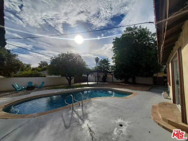 a view of a backyard with sitting area