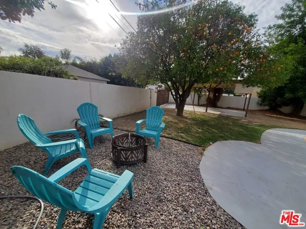 an outdoor sitting area with furniture and a yard