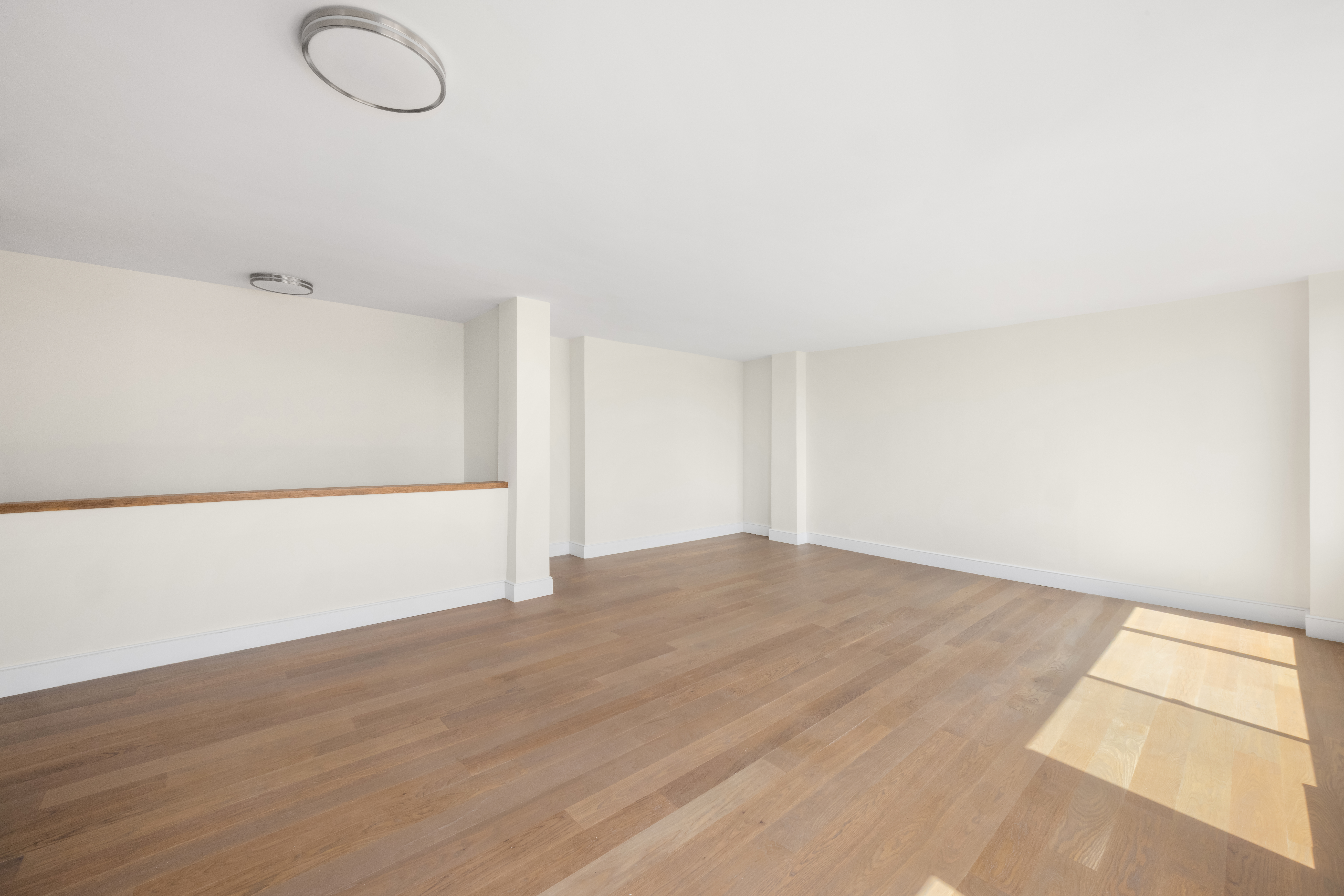 555 Main Street, Unit 1713 Manhattan, NY 10065 - Photo 3 of 9 a view of empty room with wooden floor