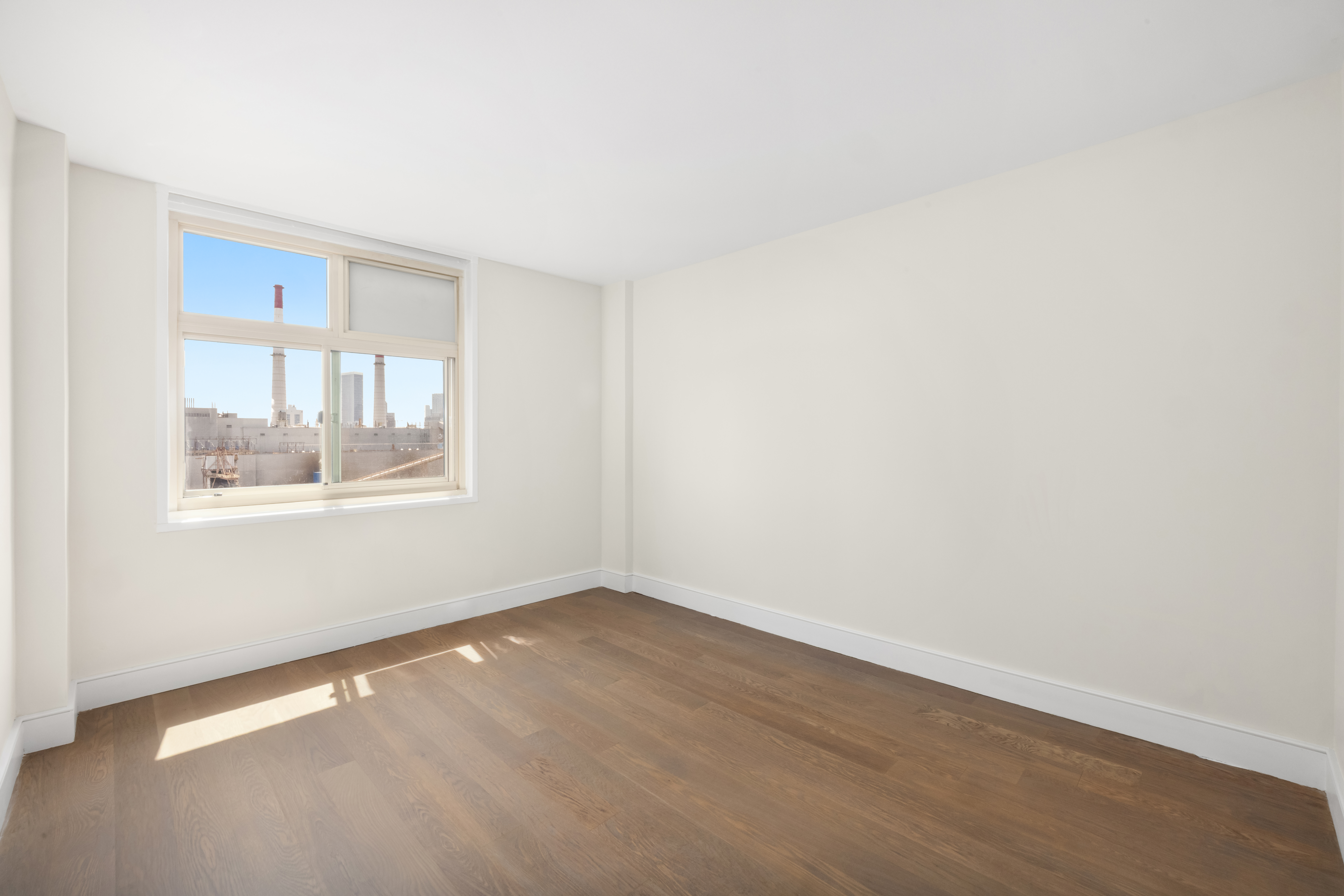 555 Main Street, Unit 1713 Manhattan, NY 10065 - Photo 8 of 9 a view of an empty room with a window