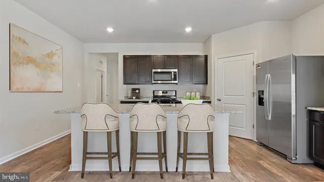 a kitchen with stainless steel appliances cabinets a microwave and a refrigerator
