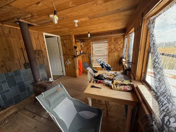 a view of a chairs and table in the backyard