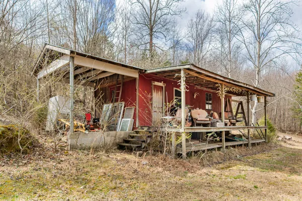a view of a yard with wooden fence