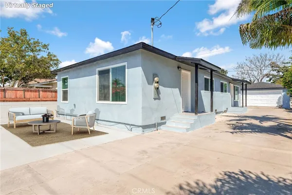 a backyard of a house with yard and outdoor seating