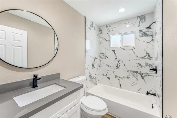 a bathroom with a sink toilet a shower and bathtub