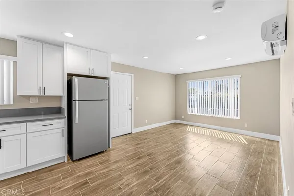 a view of a kitchen with a sink and a refrigerator