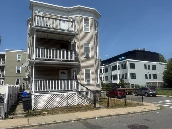 a front view of a house with a iron gate