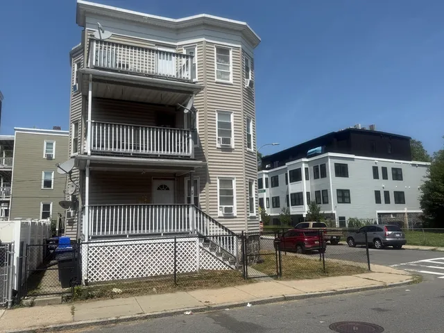 a front view of a house with a iron gate