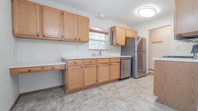a kitchen with stainless steel appliances granite countertop a refrigerator sink and cabinets