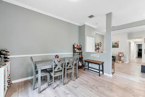 a view of a dining room with furniture and wooden floor