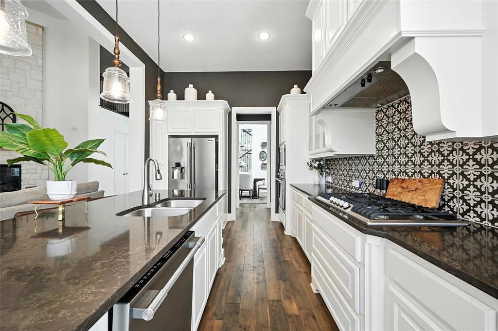 1909 Snapdragon Road Frisco, TX 75033 - Photo 12 of 40 a kitchen with stainless steel appliances granite countertop a sink a stove oven a counter space and cabinets