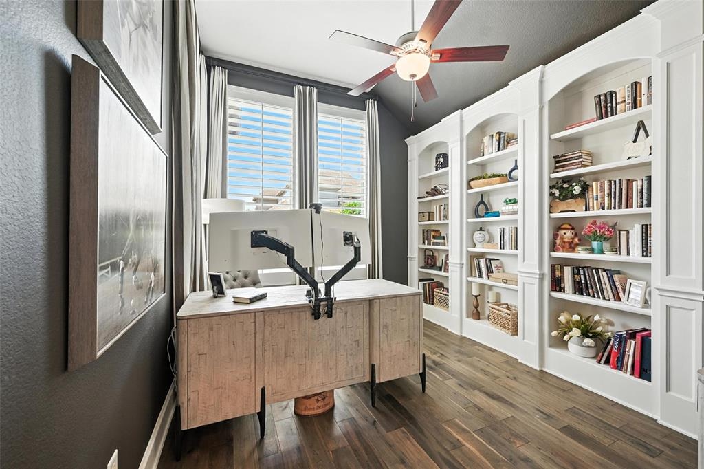 1909 Snapdragon Road Frisco, TX 75033 - Photo 16 of 40 a living room with fireplace furniture and a book shelf