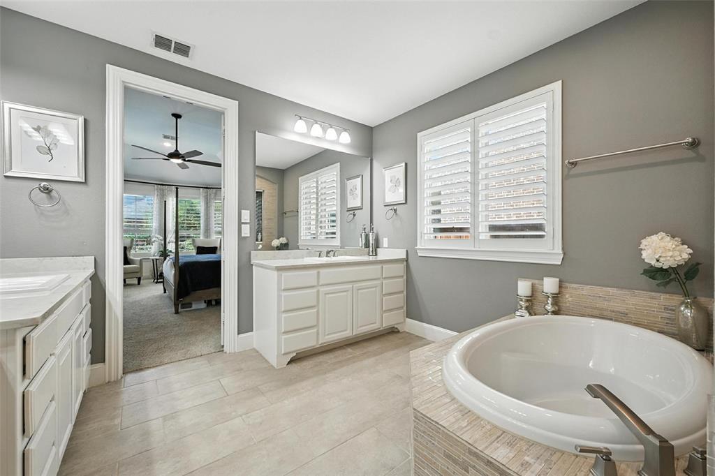 1909 Snapdragon Road Frisco, TX 75033 - Photo 19 of 40 a bathroom with a sink a vanity and a bathtub