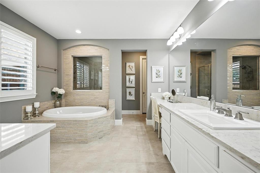 1909 Snapdragon Road Frisco, TX 75033 - Photo 20 of 40 a spacious bathroom with a granite countertop double vanity sink a mirror and a shower