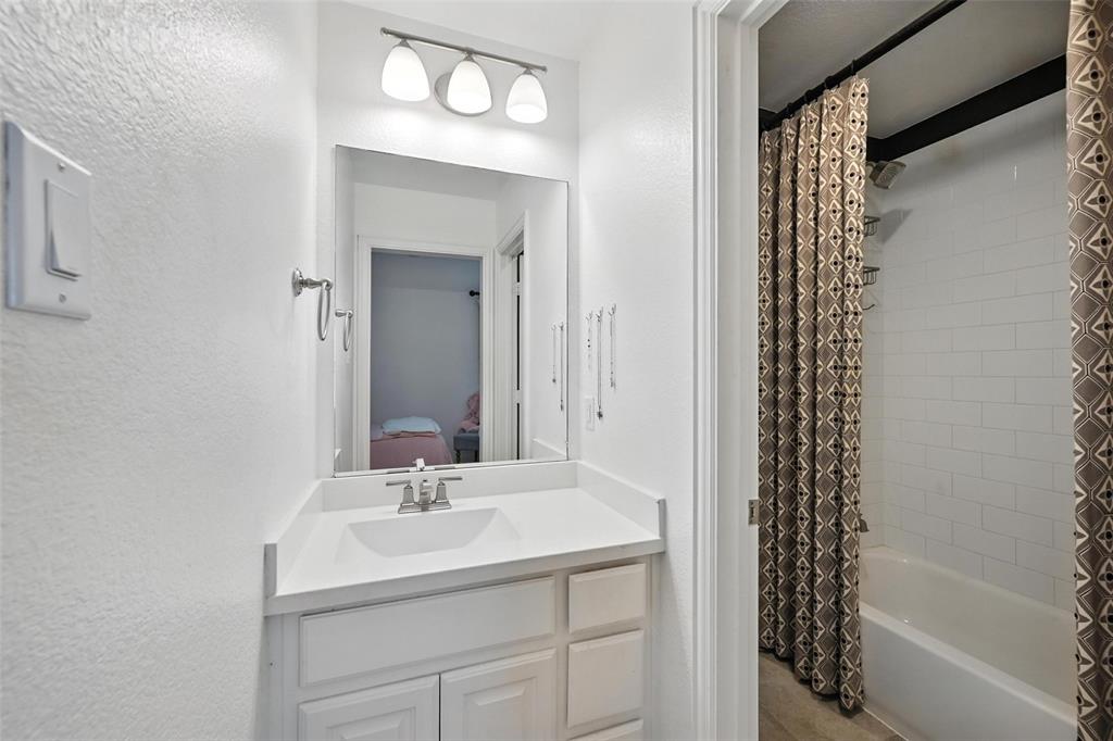1909 Snapdragon Road Frisco, TX 75033 - Photo 24 of 40 a bathroom with a sink a vanity and a mirror