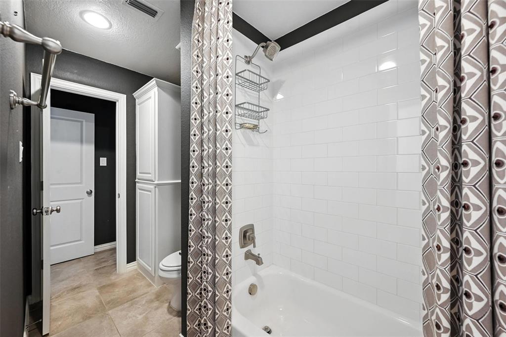 1909 Snapdragon Road Frisco, TX 75033 - Photo 25 of 40 a bathroom with a bathtub and shower