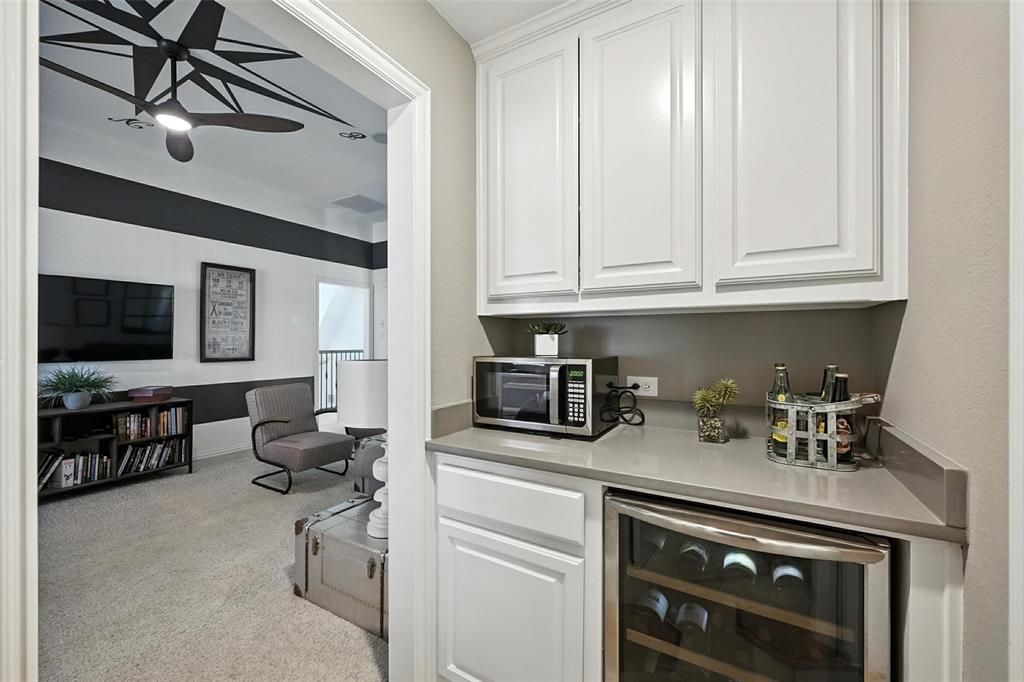 1909 Snapdragon Road Frisco, TX 75033 - Photo 26 of 40 a kitchen with stainless steel appliances granite countertop a stove and a microwave