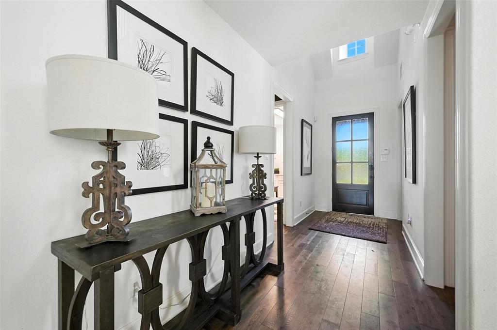 1909 Snapdragon Road Frisco, TX 75033 - Photo 3 of 40 a view of a hallway with wooden floor and staircase