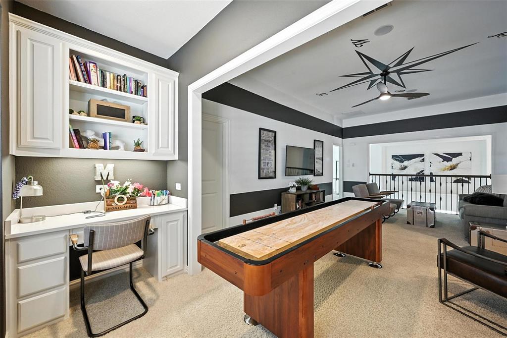 1909 Snapdragon Road Frisco, TX 75033 - Photo 32 of 40 a room with furniture a ceiling fan and a bookshelf