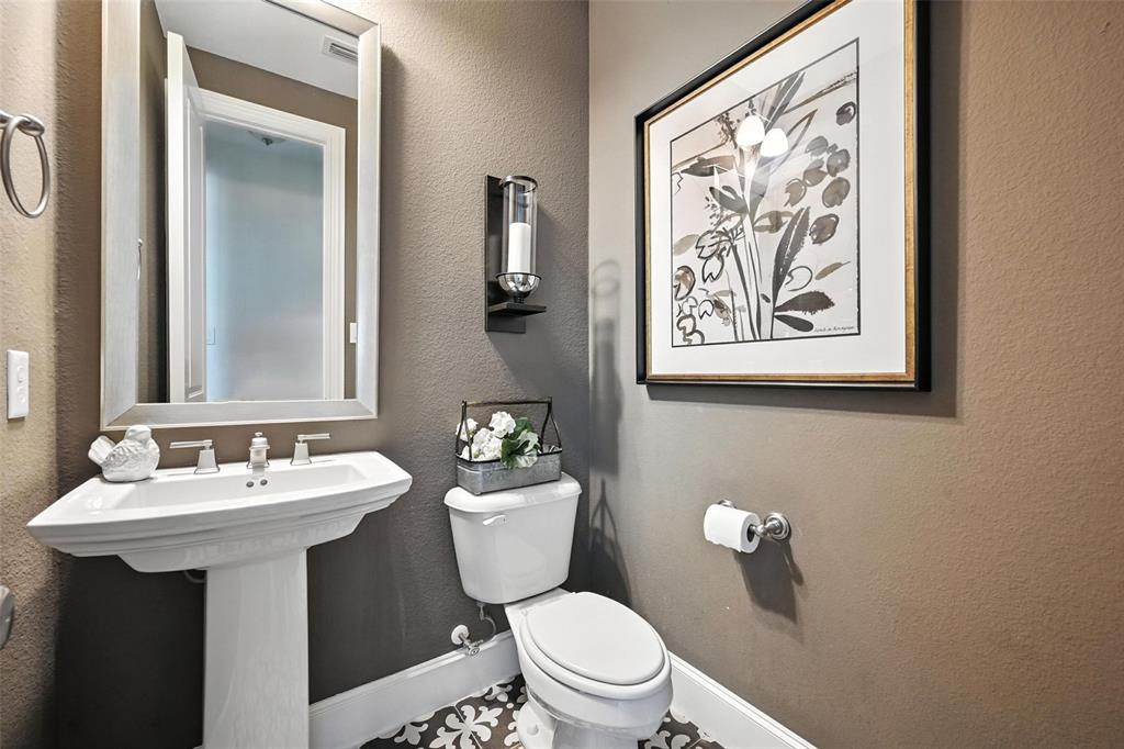 1909 Snapdragon Road Frisco, TX 75033 - Photo 8 of 40 a bathroom with a toilet sink and mirror