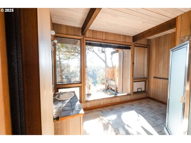 a bedroom with a bed and a large window