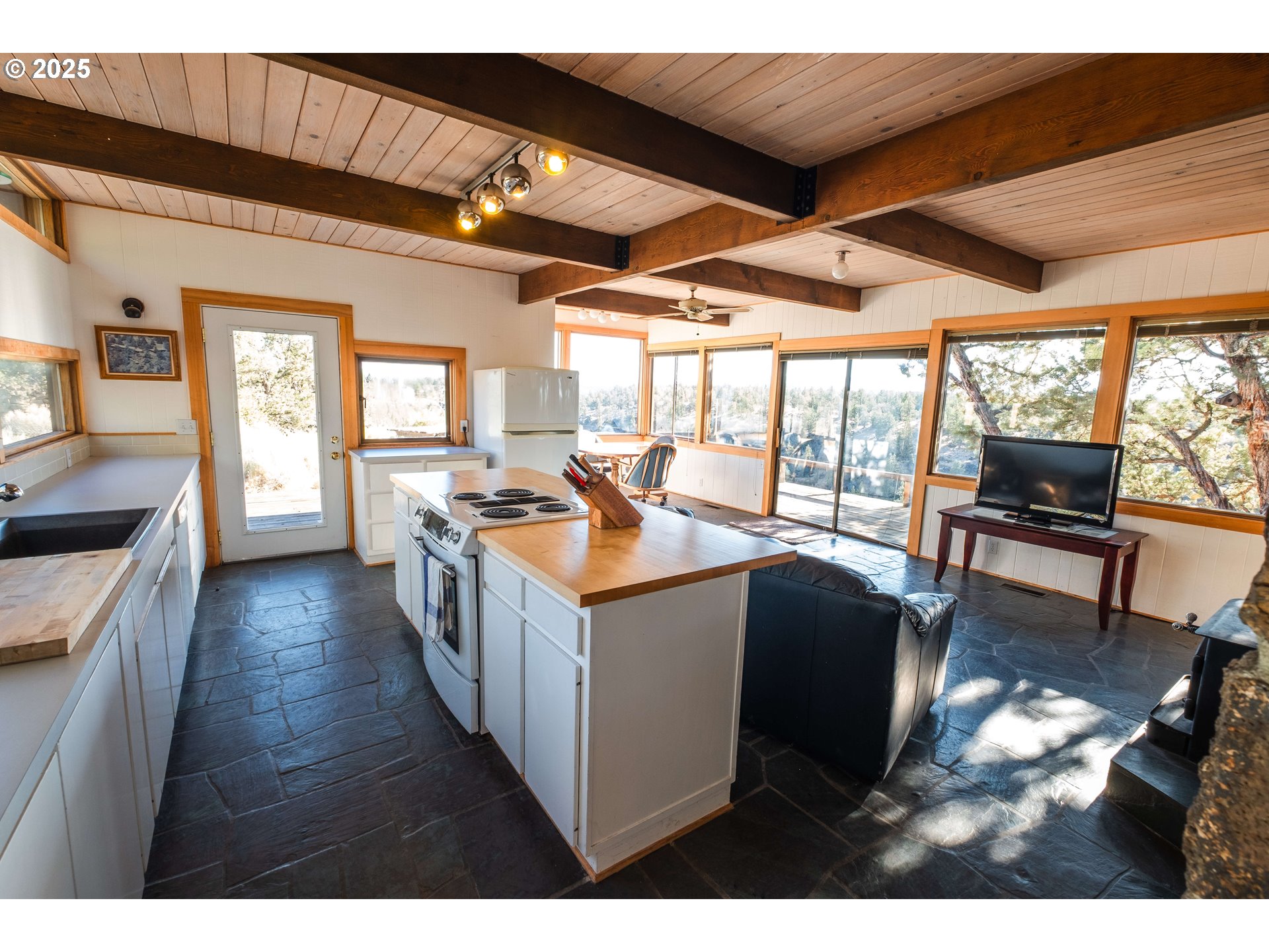 65255 Swalley Road Bend, OR 97703 - Photo 44 of 48 a kitchen with stainless steel appliances granite countertop a sink stove and wooden cabinets